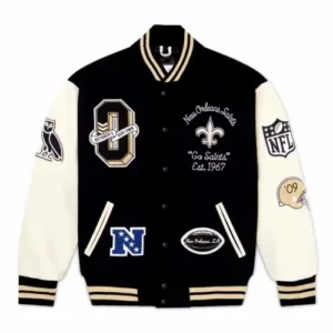 A premium black wool varsity jacket featuring cream leather sleeves, decorated with multiple embroidered patches including a large 'O' on the chest, an owl logo on the sleeve, and 'New Orleans Saints' branding.