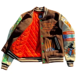 An interior view of a brown varsity jacket showing a vibrant bright orange diamond-quilted lining, highlighting the high-quality craftsmanship and warmth of the garment.
