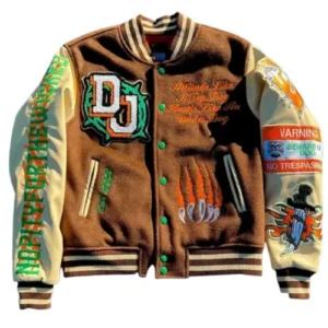 A brown wool letterman jacket with yellow-cream sleeves, featuring a large 'DU' patch with green trim on the chest and various colorful graphic patches on the sleeves and body.