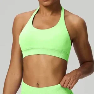 A woman wearing a bright neon green racerback sports bra with a classic scoop neckline and a wide supportive under-bust band.